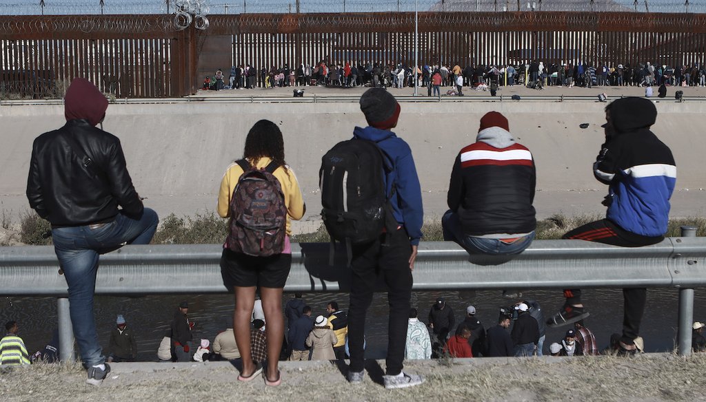 Migrants watch others stand next to the border wall in Ciudad Juarez, Mexico, Dec. 21, 2022, on the other side of the border from El Paso, Texas. (AP)